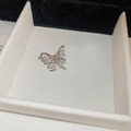 Detailed close-up of a silver butterfly ear cuff with sparkling zircon inlay in a box - Silver (Left Ear)