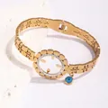 Gold hollow geometric titanium steel bracelet with devil eye pendant and sparkling rhinestones - Leaf Hollow Style