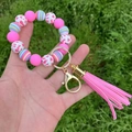 Pink silicone bead bracelet keychain with gold clasp and leather tassel on grass - Pink Heart Stripe Style / Pink