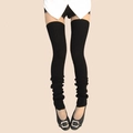 Close-up of black ribbed knit thigh-high leg warmers showing texture and slouchy fit - One Size / Black