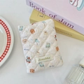 Close-up of quilted cream fabric passport cover with cute cartoon bear prints - Goodnight Bear