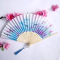 Blue gradient bamboo folding fan with pink peach blossoms and matching blue tassel - Blue Gradient Peach Blossom Landscape Style (Women's Fan 05)
