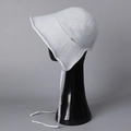 Detail of light gray knit sun hat with chin strap and wide wavy brim on model - M(56-58cm) / Gray