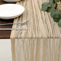 Macro detail of beige wrinkled gauze table runner on wood with dinnerware - Beige