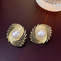 Detailed view of gold spiral metal earrings with pearls on dark brown leather texture - Gold Swirl Surrounding Pearl Style (30#)