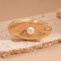 Macro detail of oval gold ring featuring spiral texture and central white faux pearl inlay - Open (Gold) / Gold