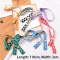 Close-up of adjustable chevron knit straps in various colors with metal buckles - Patterned Strap