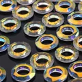 Faceted AB iridescent crystal glass spacer beads with colorful shimmer on black background - 10MM Angel Ring