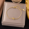 Close-up of gold stainless steel snake chain bracelet featuring a minimalist knot detail - Gold Knot Snake Chain Bangle