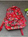 Detailed shot of traditional Chinese floral print backpack with red nylon straps and zippers - Red