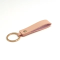 Pink PU leather keychain with gold hardware ring and rivet in a minimalist design - Apricot & Gold