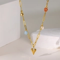 Detail of gold heart pendant necklace with orange stone, blue bead and pearl accents - Natural Stone Heart Necklace / Gold