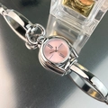 Close-up of a vintage silver watch with pink dial and chain strap on reflective surface - Silver Case Pink Dial