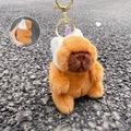 Plush capybara keychain with white hat and purple horns on a golden metal ring - Unicorn Headwear