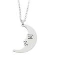 Detailed close-up of a silver crescent moon pendant necklace with a cutout face design - Smiling Moon / Silver