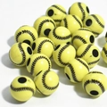 Macro view of yellow acrylic baseball beads with black stitching and central threading holes - 12mm Baseball Yellow Background Black Line