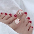 Close-up of cherry pattern and vibrant red finish on wearable press-on toenails - No Accessories Style