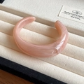 Detail of pink marble resin open bangle with irregular wave design on velvet display - Pink Drift Sand