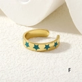 Detail of adjustable gold ring featuring deep teal enamel stars and a smooth metallic finish - Cyan-Blue Stars (RG0441-F)