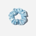Light blue satin silk scrunchie with soft pleats and elegant sheen on grey background - Blue