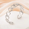 Elegant silver open bangle featuring hollow heart design on a textured stone base - Hollow Heart / Steel