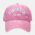 Close-up of Swiftie Est. 1989 white embroidery on a pink washed cotton baseball cap - Pink