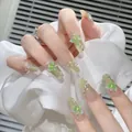 Detail of long coffin press-on nails with green gradient and 3D butterfly charms - Z679 The Wizard Of Oz / Nail Glue Version
