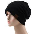 Detail of black slouchy beanie featuring a premium brown leather logo patch and knit texture - 56-61cm / Black