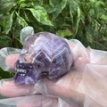 Handheld 5cm natural amethyst crystal skull with hand-carved details and polished finish - Purple Crystal