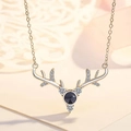Detail of deer antler necklace featuring a black projection stone and zircon accents - Buck Antler White Gold Color