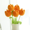 Handmade knitted bouquet with five orange tulips in a white vase by a bright window - Plump Tulip Orange
