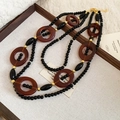 Detail of layered ethnic fringe necklace with black resin beads and gold accents - Necklace-Black-Coffee