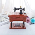Vintage sewing machine music box with wood grain base and miniature fabric accessories - Large Retro Sewing Machine Style