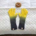 Close-up of yellow and grey gradient knitted gloves with a compass logo tag - Yellow