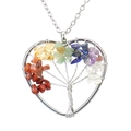 Macro shot of silver-tone tree of life heart pendant with multicolor gemstone chips - Rainbow