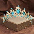 Macro detail of golden bridal tiara with sparkling blue teardrop rhinestones - Gold + Light Blue Rhinestone