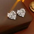 Macro shot of silver heart studs with clear cubic zirconia on a brown leather texture - Heart Studs / Silver (Silver Pin)