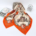 Detail of satin scarf featuring orange horse carriage and chain print styled with a handbag - 90*90cm / Orange
