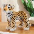 Realistic leopard plush toy with yellow spotted fur standing on a wooden surface - 38cm / Leopard