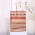 Detail of brown kraft gift bag with festive reindeer and snowflake patterns on a pedestal - Stocking & Reindeer (019-5)