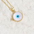 Golden necklace with circular white and blue Evil Eye resin pendant in a minimalist design - White