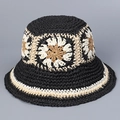 Detail of handmade straw hat featuring crochet sun flower patterns and woven texture - Black