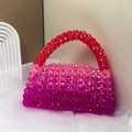Close-up of handmade beaded bag featuring red gradient acrylic beads on white fabric - Gradient Red