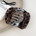 Macro detail of tortoiseshell hair claw clip displayed on a minimalist ceramic plate - Large Gray Tortoise