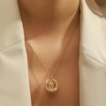 Elegant gold plated Virgin Mary pendant necklace with zircon halo on model's neck - Round Virgin Mary (YSN105GL)
