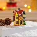 Macro detail of glowing resin Christmas village house with warm LED light on fake snow background - Style H