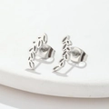 Close-up of silver stainless steel earrings with minimalist hollow wheat leaf design - Wheat Steel