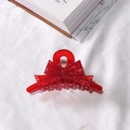 Deep red bow-shaped acetate hair claw clip with translucent finish and metal spring - Red