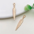 Pair of rose gold feather pendants crafted from zinc alloy for DIY jewelry making - 1 Piece/Pack (15x28mm)