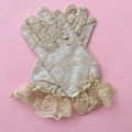 Close-up of beige lace gloves featuring floral patterns and elegant ruffled wrist details - Kids One Size / Nude